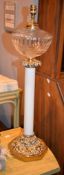 A late Victorian opaque white and clear glass gilt metal mounted paraffin lamp, of columnar form,
