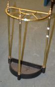 A Brass stick stand with integral cast iron drip pan base, late 19th century,