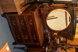 An Edwardian mahogany and inlaid dressing table with circular mirror to the upstand above three long