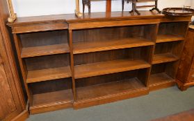 An oak breakfront bookcase with adjustable shelves, 112cm high, 214cm wide overall, 33cm deep
