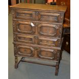 An oak chest on stand in Caroleon style, with four long drawers each with geometric moulded