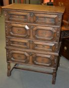 An oak chest on stand in Caroleon style, with four long drawers each with geometric moulded