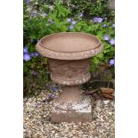 A campana shaped garden urn and base, 58cm high