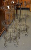 A pair of French three tier wirework jardinière stands, each 109cm high