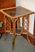 A Victorian bamboo and lacquer two tier occasional table, 77cm high, the top with central lacquer