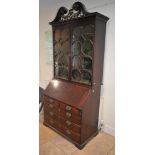 A George III mahogany bureau, the fall enclosing a fitted interior with pigeonholes and drawers,