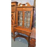 An Edwardian mahogany and satinwood inlaid bookcase on stand, with broken pediment, 193cm high, 91cm