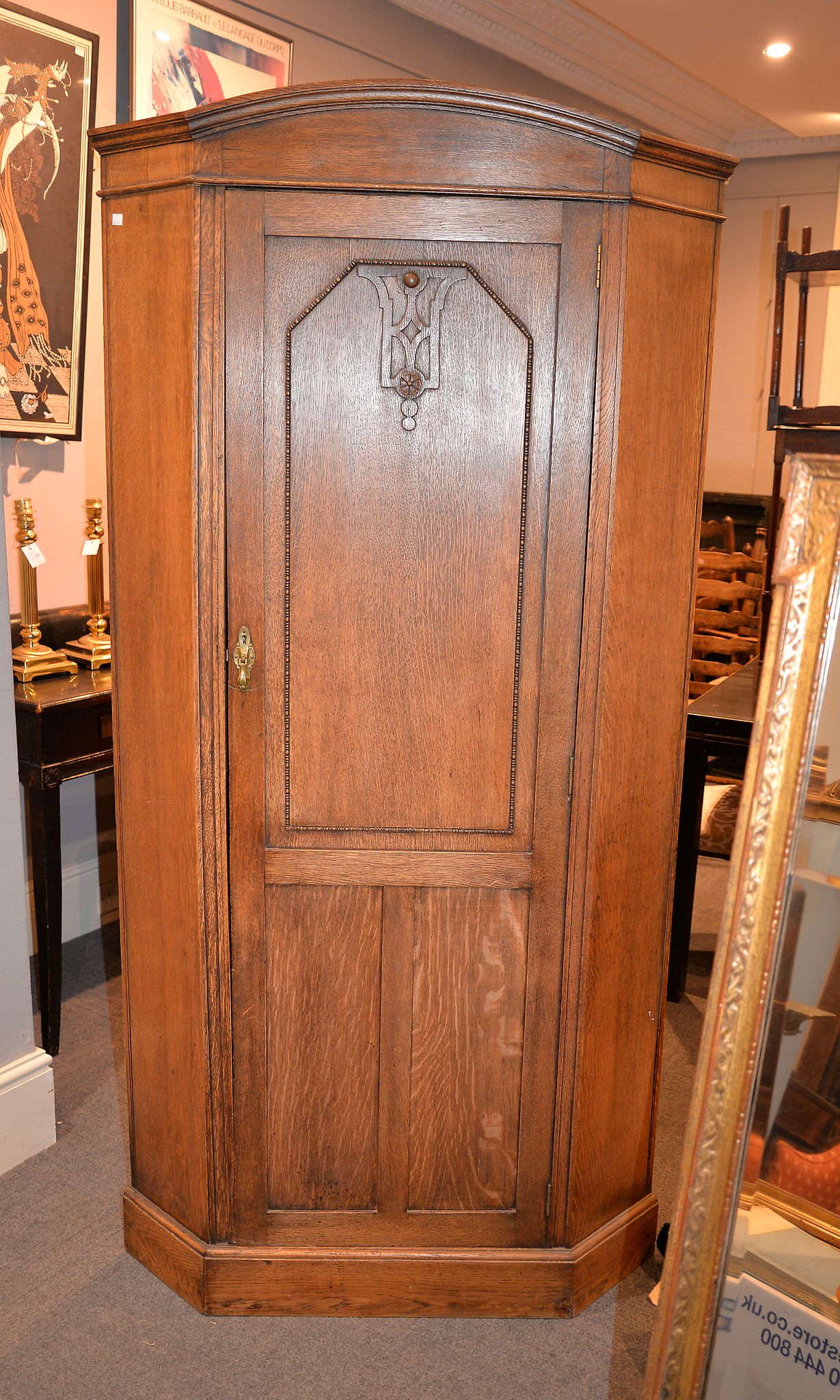 An oak corner wardrobe in Arts and Crafts taste, 196cm high