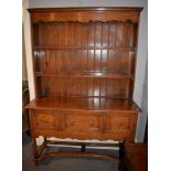 An oak dresser in George II style, 20th century, with plate rack superstructure above base with