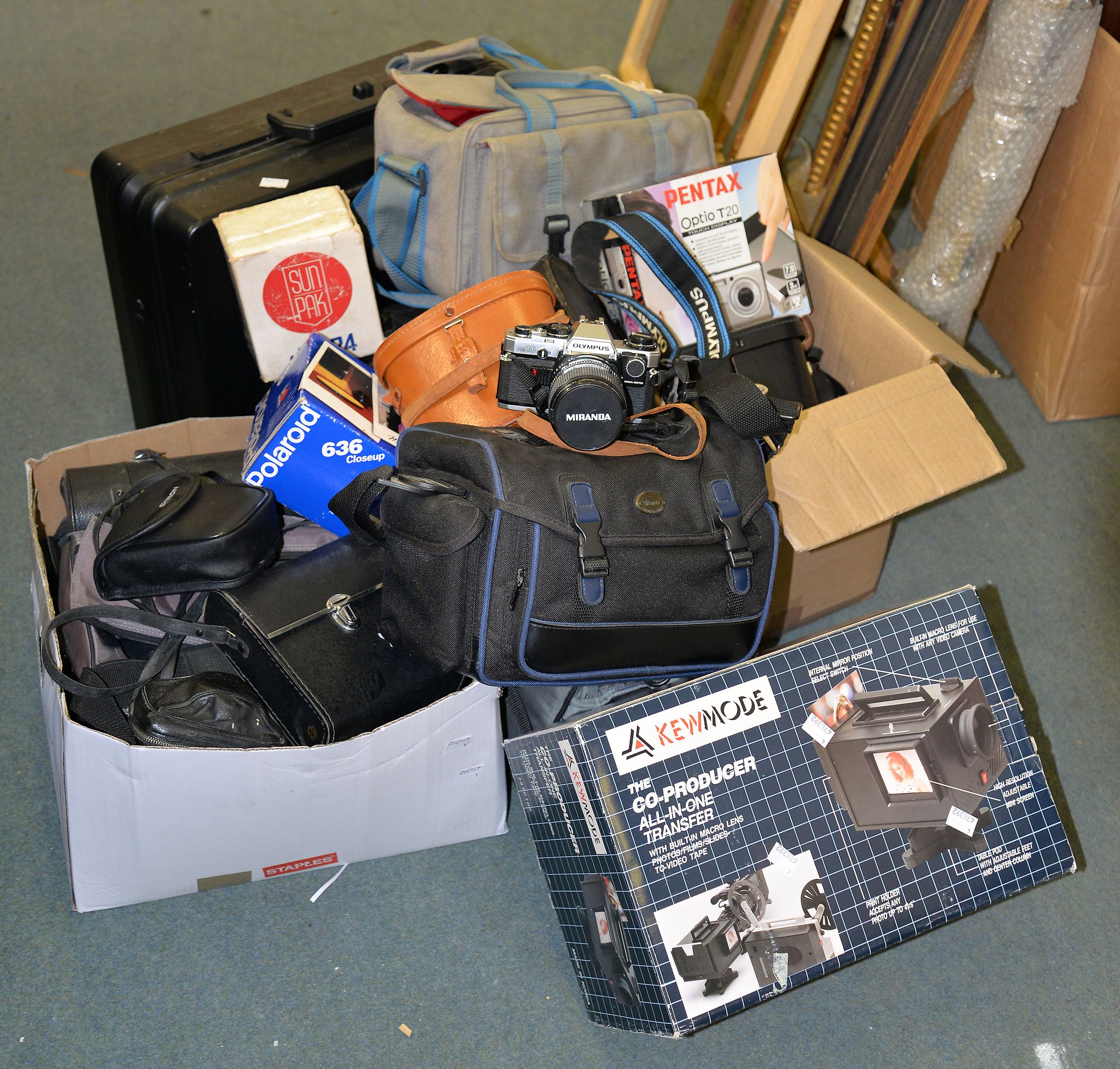 A collection of various cameras, video recording equipment, and field glasses, including an