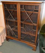An Edwardian mahogany and inlaid bookcase, the astragal glazed doors enclosing adjustable shelves,