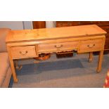 A pitch-pine low side table in Chinese taste, with three frieze drawers, 70cm high, 137cm wide, 40cm