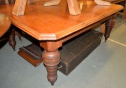 A late Victorian walnut extending dining table, with four loose leaves, in the manner of Fitter's