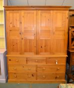 A pine cupboard, with four doors above drawers, 207cm high, 166cm wide