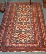 A Caucasian rug with stylised flower heads on a blue ground within multiborders,