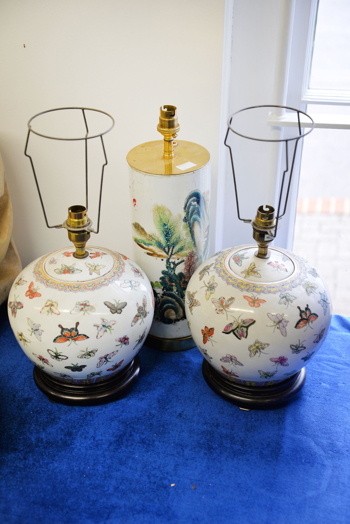 A Chinese Famille Verte cylindrical porcelain vase fitted for electricity as a lamp, and two other