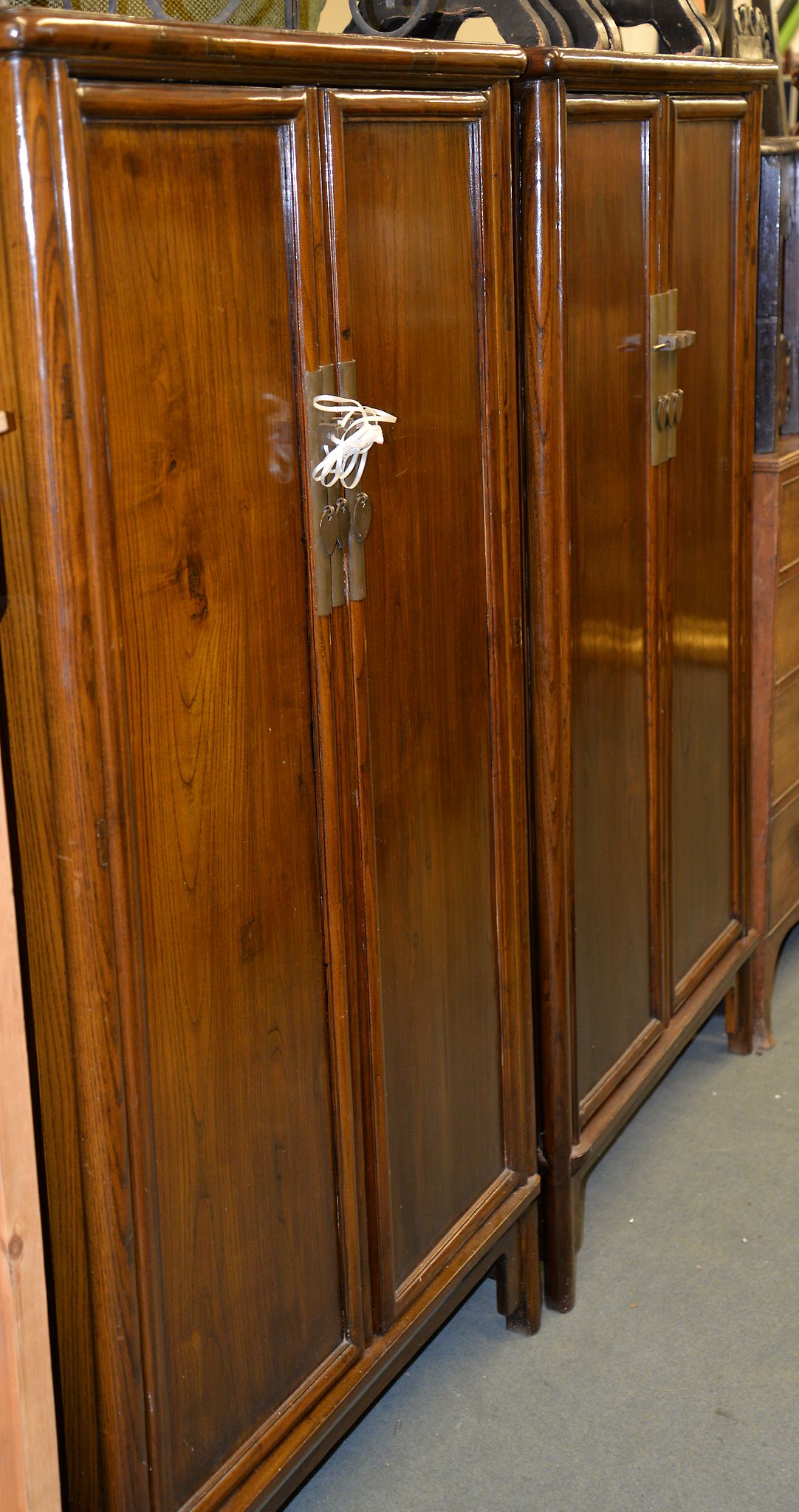 A pair of modern Chinese hardwood two door cupboards, each 165cm high, 86cm wide, 46cm deep