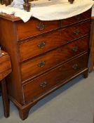 A George III mahogany and cross banded chest of drawers, with two short and three long drawers