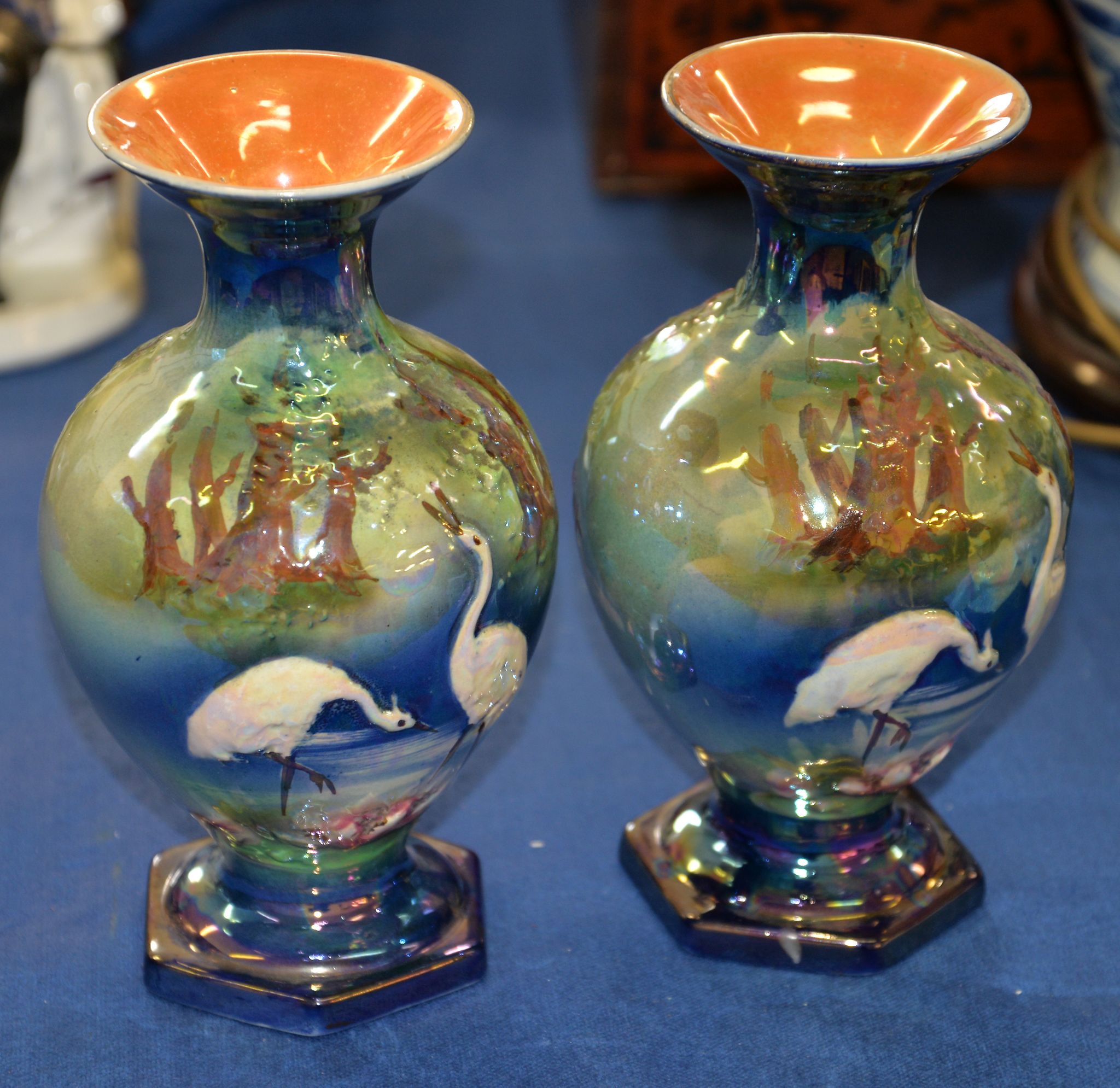 A pair of English pottery lustre glazed baluster vases, circa 1900, moulded in relief with cranes in