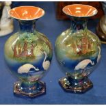 A pair of English pottery lustre glazed baluster vases, circa 1900, moulded in relief with cranes in