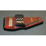 A stained wood Autoharp (zither), and an associated zither playing manual