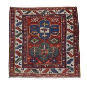 A Kazak rug , with typical geometric patterns overall, approximately 142cm x120cm, Provenance: The