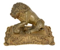 A French gilt bronze letter clip cast as a seated lion, mid-19th century, with sprung jaw, on a