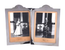 [Elizabeth II and Prince Philip] A pair of signed photographs in silver frames by Henry Hodson