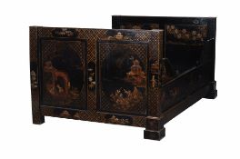 A black lacquered, and parcel gilt decorated bed , late 19th century, the head and foot boards with