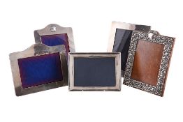 Five rectangular photograph frames, comprising: a scroll foliate embossed example by Deakin &