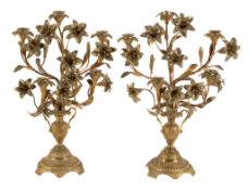 A pair of French gilt bronze five light candelabra, circa 1880, the sockets on foliate stems