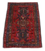 A Chondoresk Kazak rug , the madder field with three medallions, flowers and human figures
