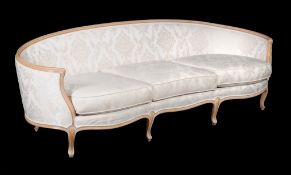 A beech and damask upholstered sofa, in Louis XV style, 20th century, the moulded arched back above