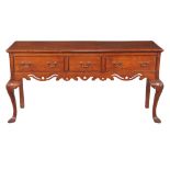 An elm sideboard in George II style , early 20th century, with three frieze drawers above a