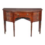 A Regency mahogany and inlaid sideboard , circa 1815, of bowfront outline, with central frieze