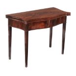 A George III mahogany card table , circa 1790, of serpentine outline, with a baise inset playing