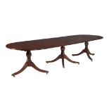 A mahogany triple pillar dining table in Regency style , 20th century, with two additional leaf