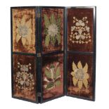 An ebonised three fold screen, the panels with 19th century embroidered velvet panels depicting