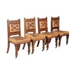 A set of four carved Victorian Gothic Revival oak side chairs , circa 1890, each with button