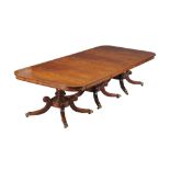 Ω A mahogany triple pillar dining table, circa 1820 and later, the later large rectangular top