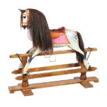 A rocking horse, by Stevenson Brothers , dated 2006, the dappled grey horse with leather tack and