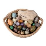 A collection of twenty-four polished hardstone and mineral specimen eggs, including two malachite