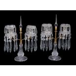 A pair of gilt bronze mounted cut glass twin light lustre candelabra, second quarter 19th century,