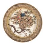 A George III circular paper-scroll picture , circa 1780, depicting a spray of flowers within a