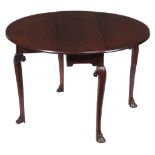 A George II Irish mahogany drop leaf table , circa 1750, the oval top incorporating twin hinged