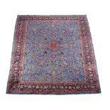 A Khorassan carpet , the blue field decorated profusely in pinks and reds with floral branches and