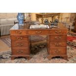 A George III mahogany twin-pedestal partner s desk , circa 1800, the gilt tooled leather inset top