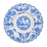 A Dutch Delft blue and white dish in the Transitional style , circa 1700, of fluted form, cracked ,
