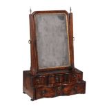 A George I walnut dressing mirror, circa 1720, the moulded frame with a gilt sight edge, the