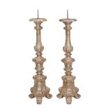 A pair of carved and silvered wood pricket altar sticks, 18th century, each iron pricket above the